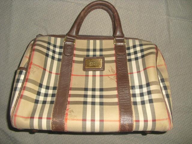 Front view of a Burberry canvas Boston bag showing leather handles, trim, and classic check pattern.
