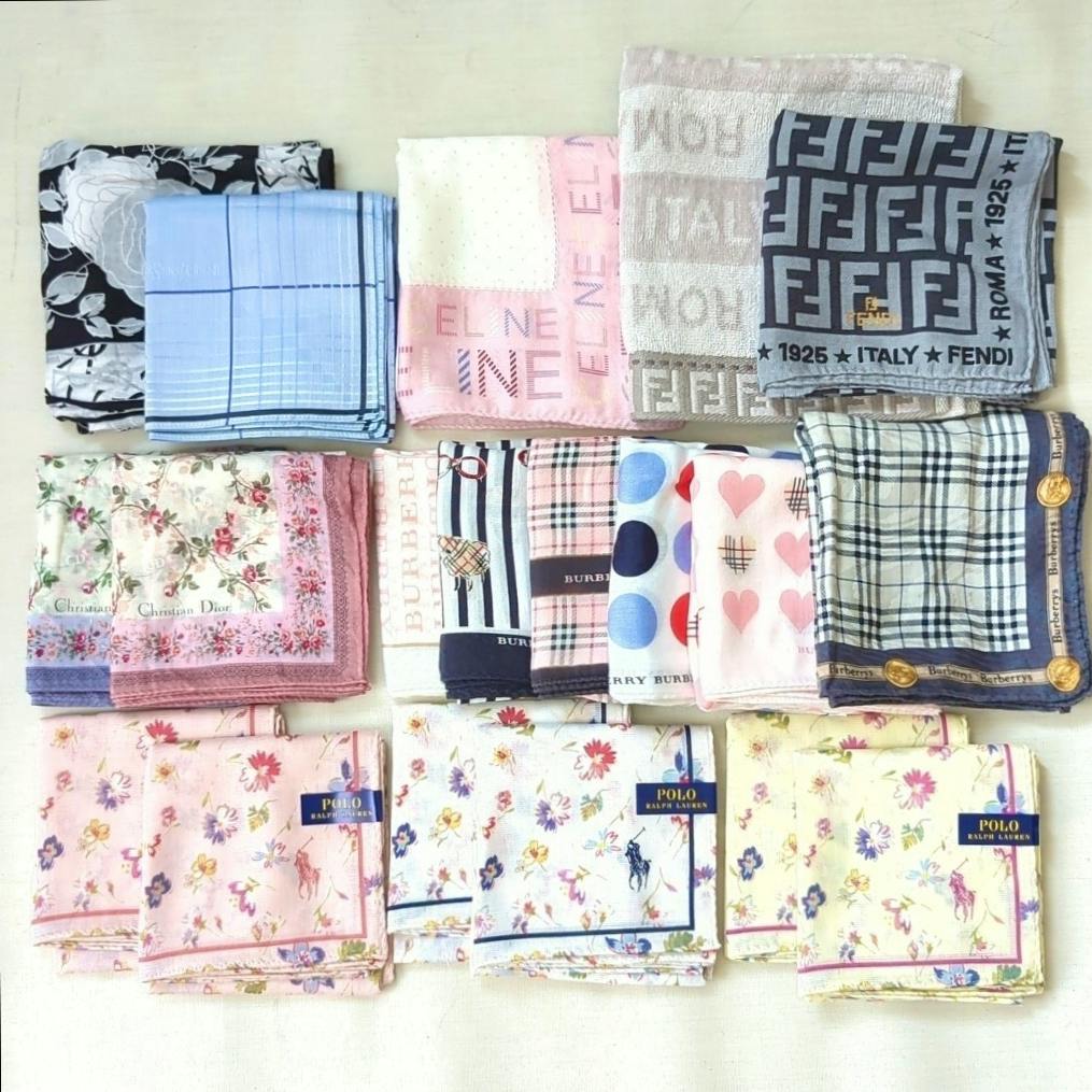 A set of folded cotton handkerchiefs and small towels in various patterns arranged in rows on a light background.