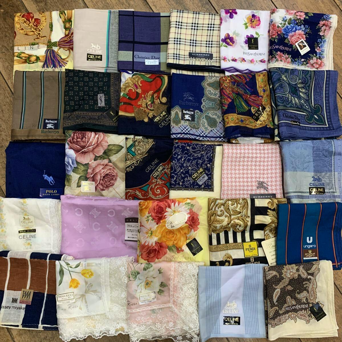 Many folded branded handkerchiefs in various colors and patterns arranged in a grid on a wooden surface.