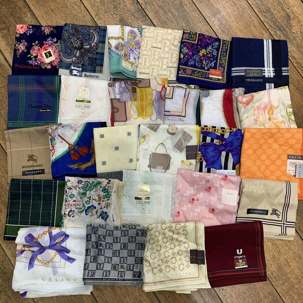 A laid-out assortment of branded cotton handkerchiefs displayed on a wooden floor.