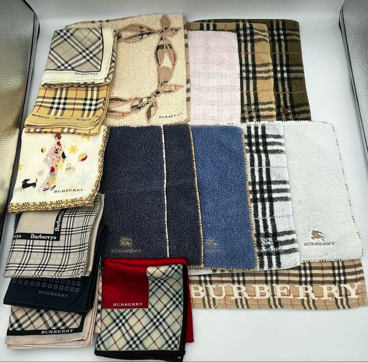 A collection of folded Burberry hand towels and handkerchiefs laid out on a white background, showing various check patterns and logos.
