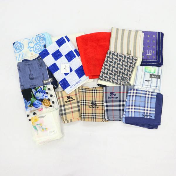 Flat lay of folded handkerchiefs and small towels in assorted patterns and brands, including Burberry and DKNY.
