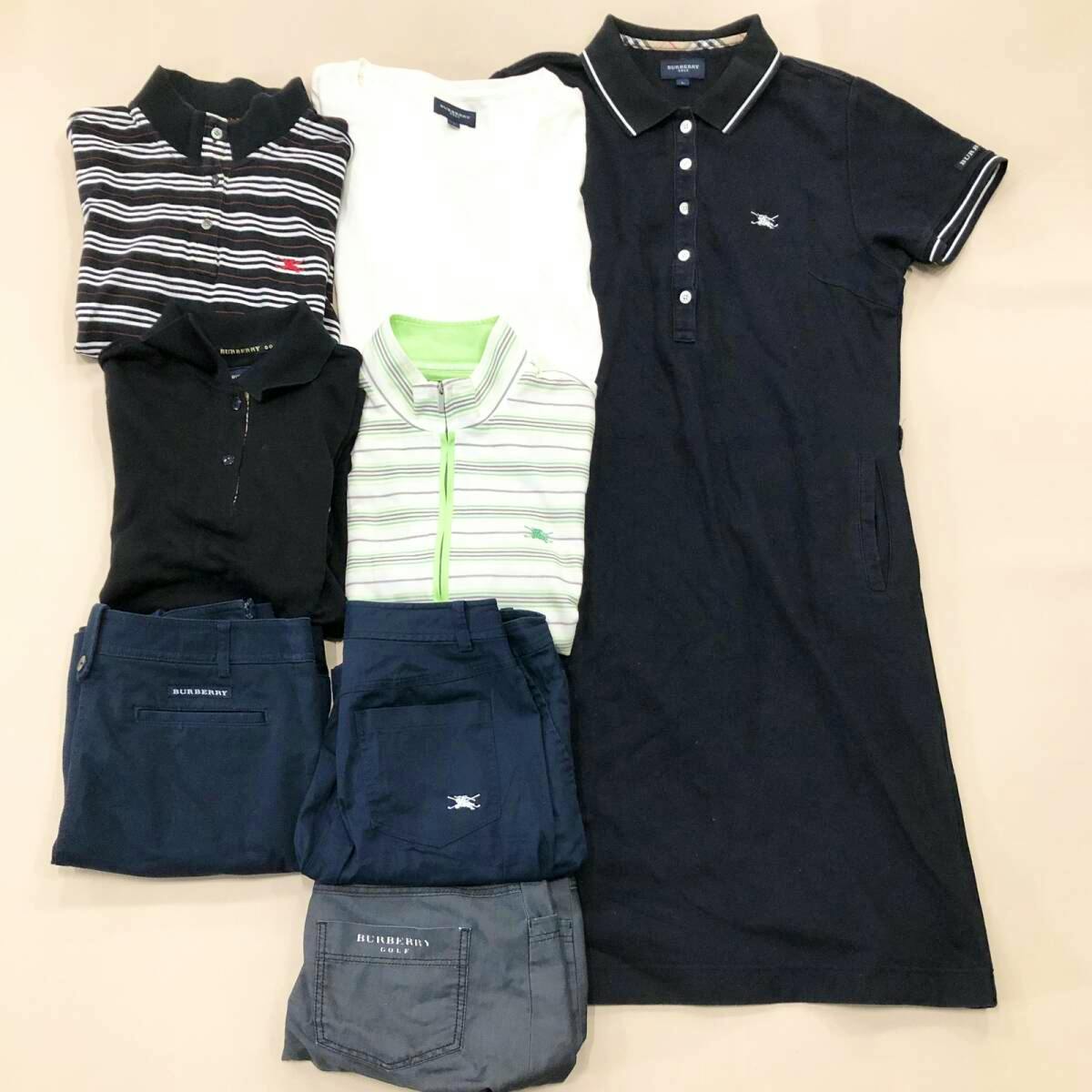 Several Burberry Golf women’s garments (folded tops, a navy polo dress, and pants) arranged flat on a light background.