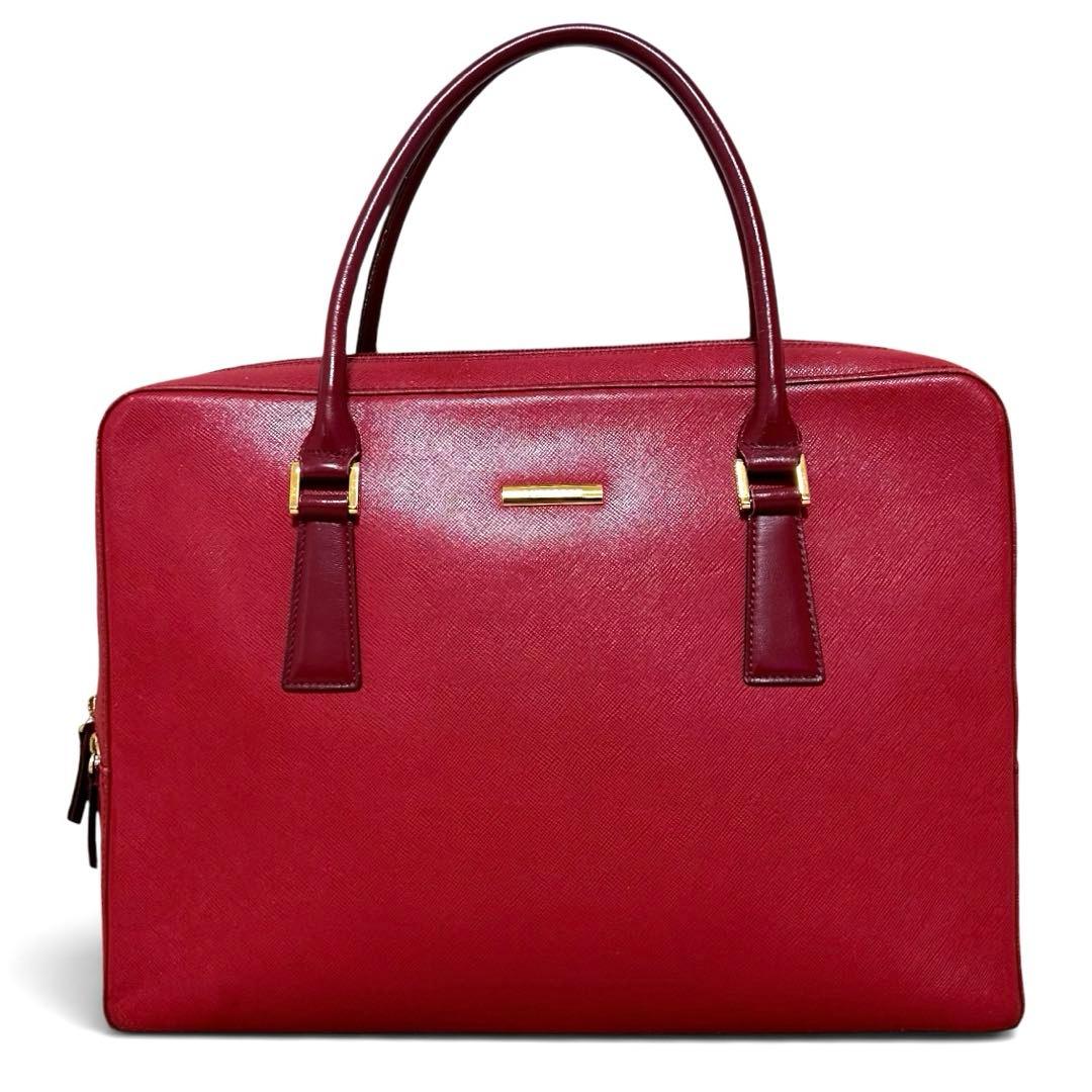 Red leather BURBERRY business briefcase with top handles and gold hardware shown front-on.