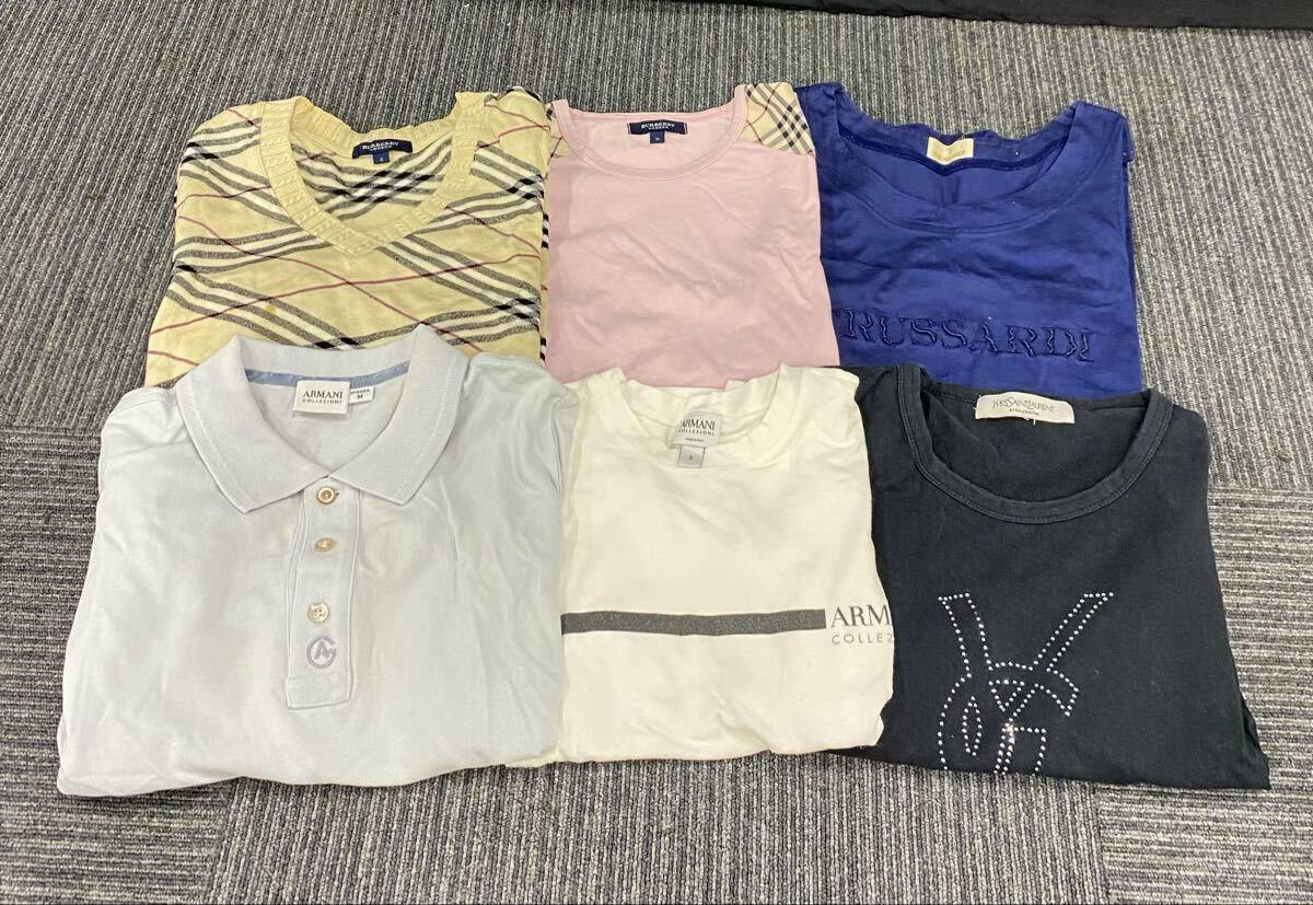 Seven folded men's tops (mixed short-sleeve, long-sleeve, and sleeveless cotton shirts) laid flat on a gray carpet showing various colors and patterns.