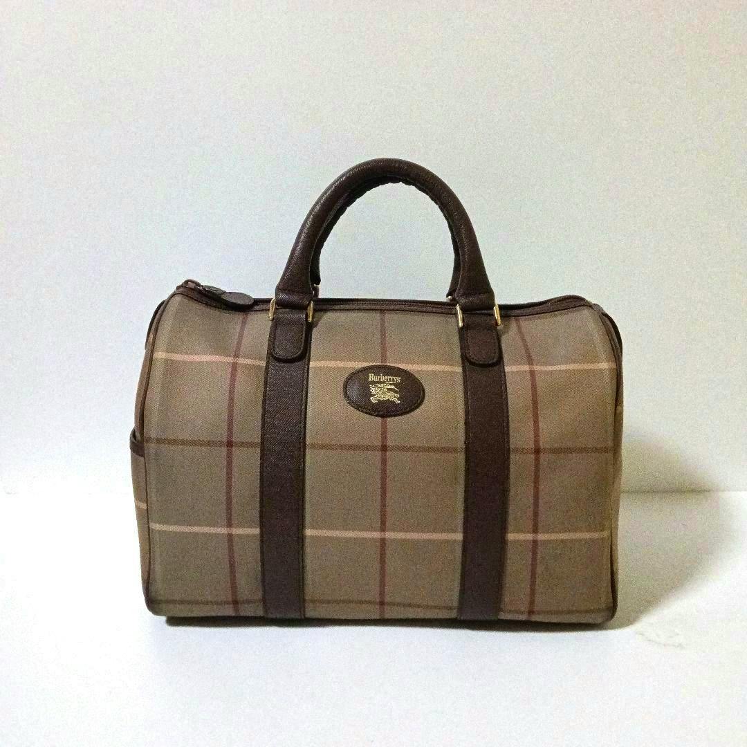 Front view of the Burberry mini boston canvas bag in check pattern with dark brown handles and trim.