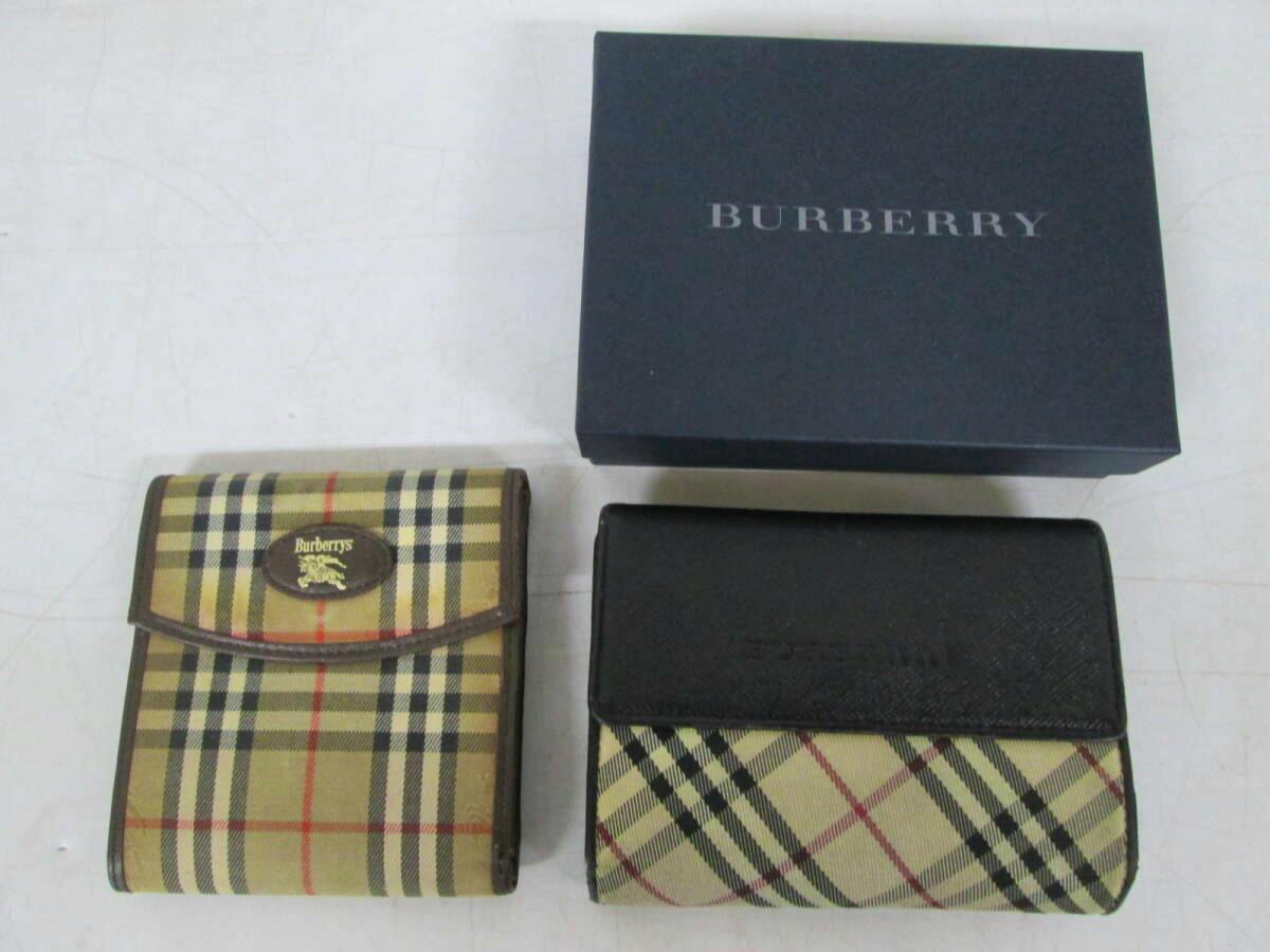 Two Burberry Nova check folding wallets displayed with a Burberry box on a white surface.
