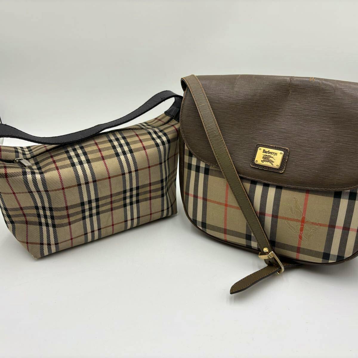 Two Burberry bags in Nova Check canvas with brown leather trim: a flap shoulder bag with strap and a smaller zip pouch on a white background.