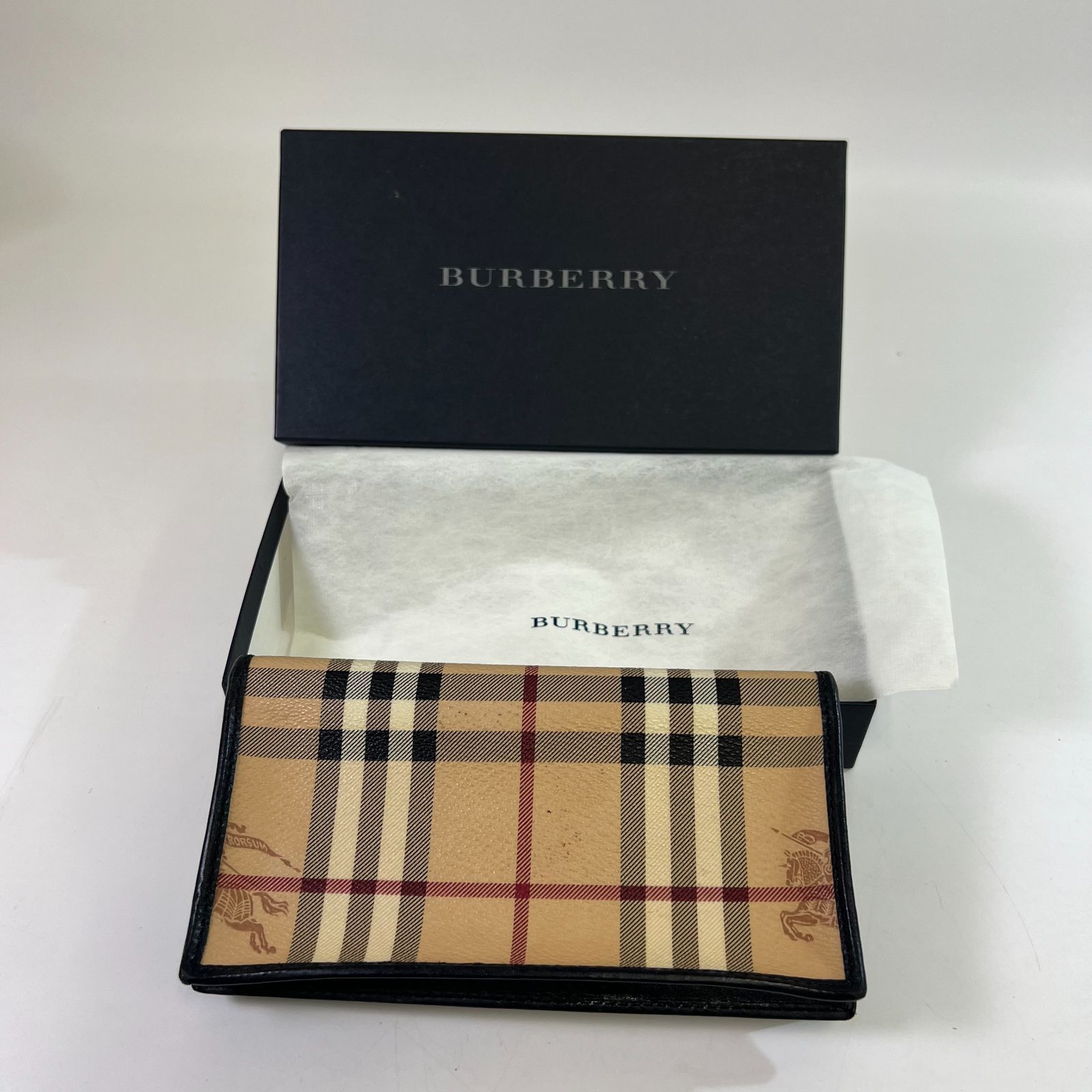 Beige Burberry Nova Check long wallet with black leather trim displayed with a Burberry box and tissue.