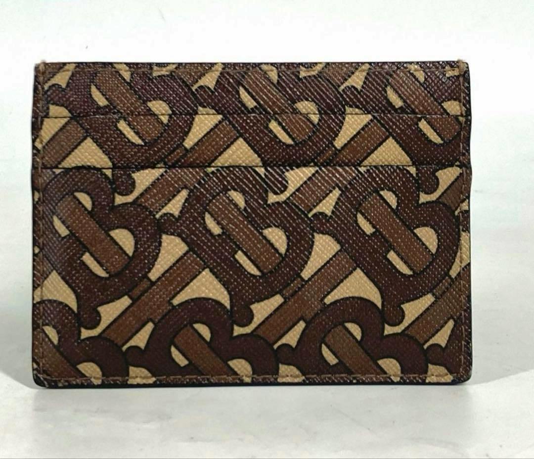 Front view of the brown BURBERRY TB monogram card case in cow leather showing the patterned exterior and card slots.