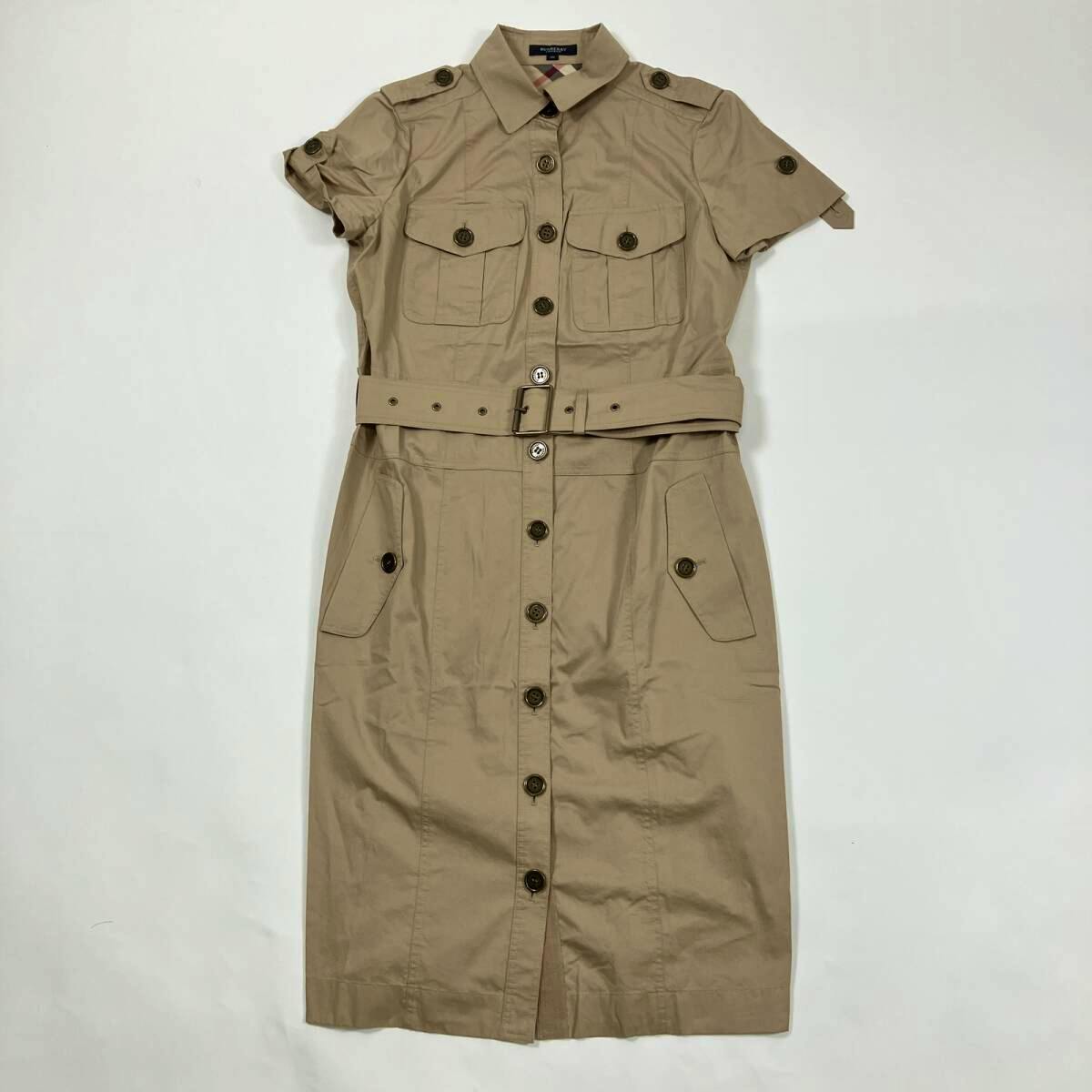 Beige short-sleeve Burberry military-style cotton shirt dress with front buttons and a belt laid flat on a white background.