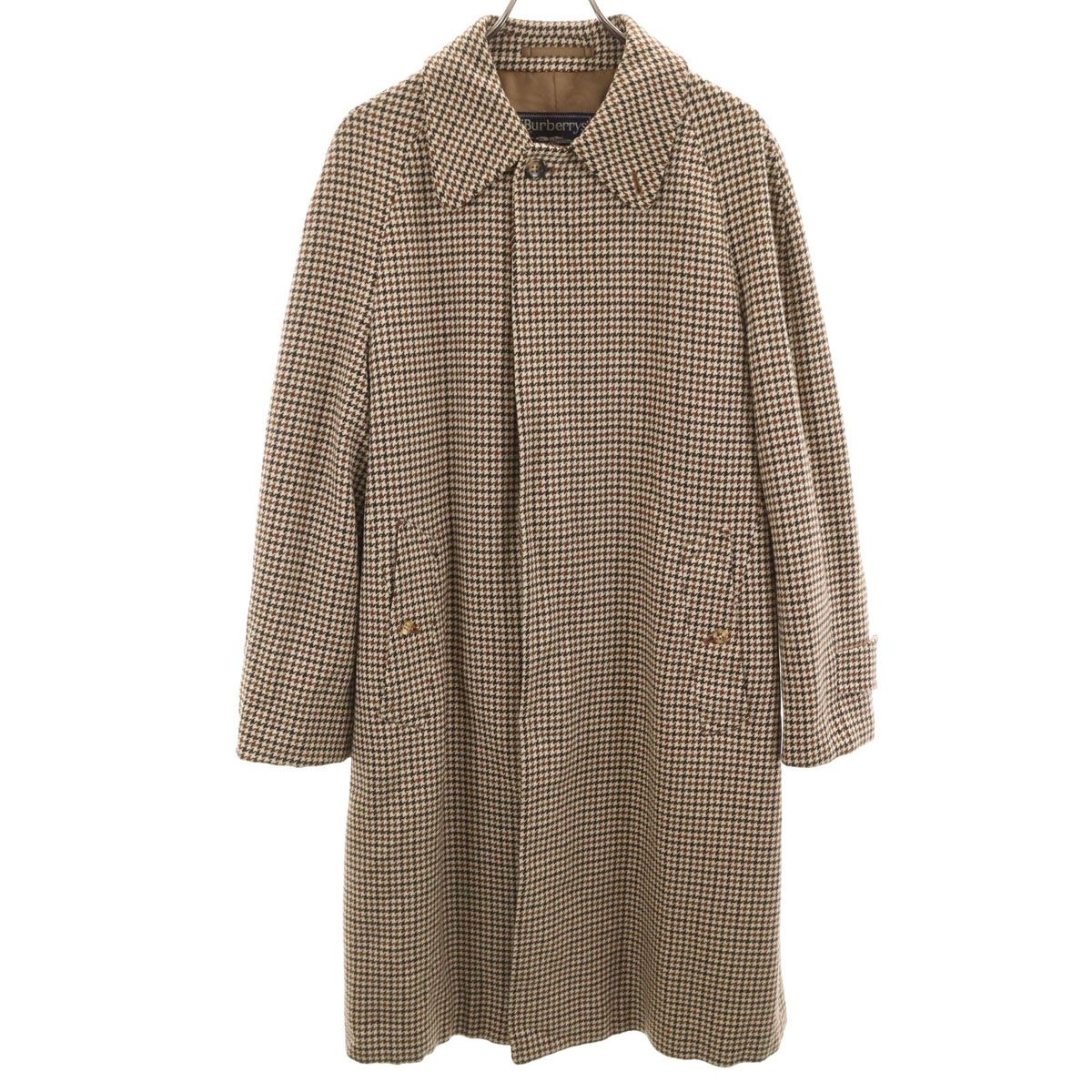 Front view of a brown houndstooth men's Burberrys long coat displayed on a hanger.