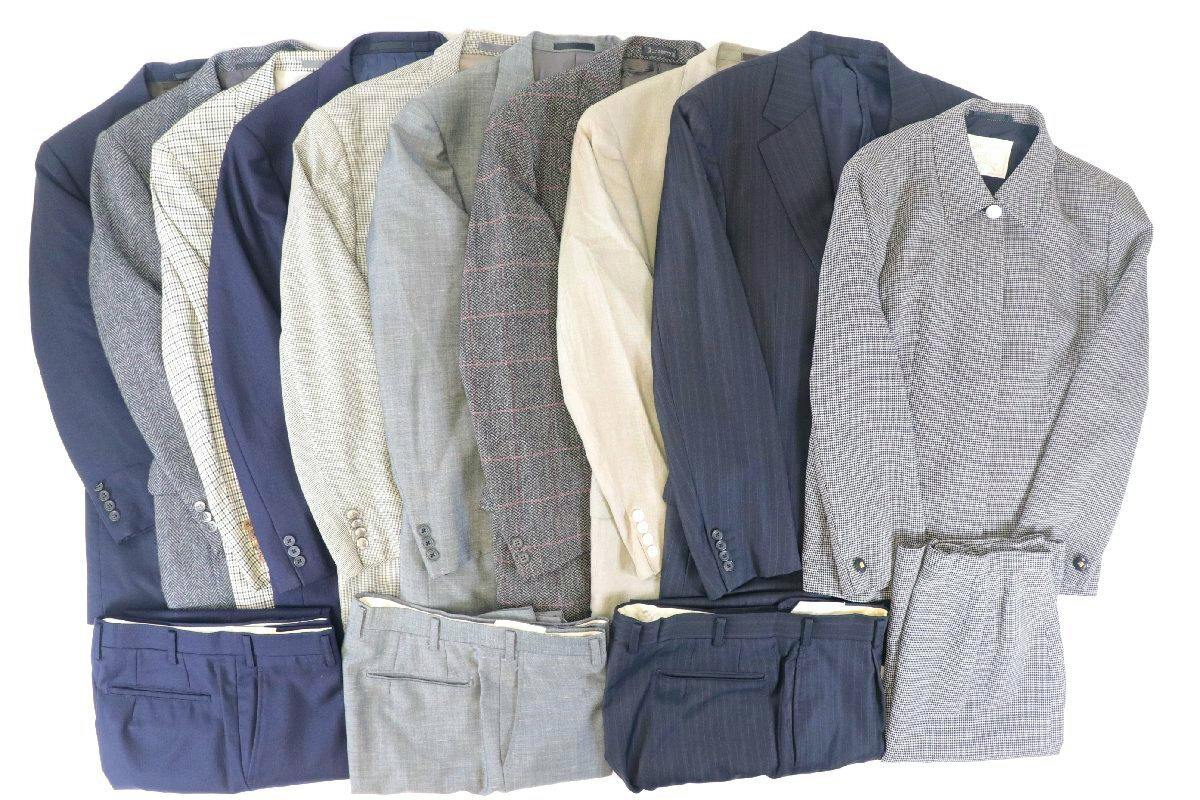 Several men's jackets and folded trousers laid side by side showing different colors and patterns.