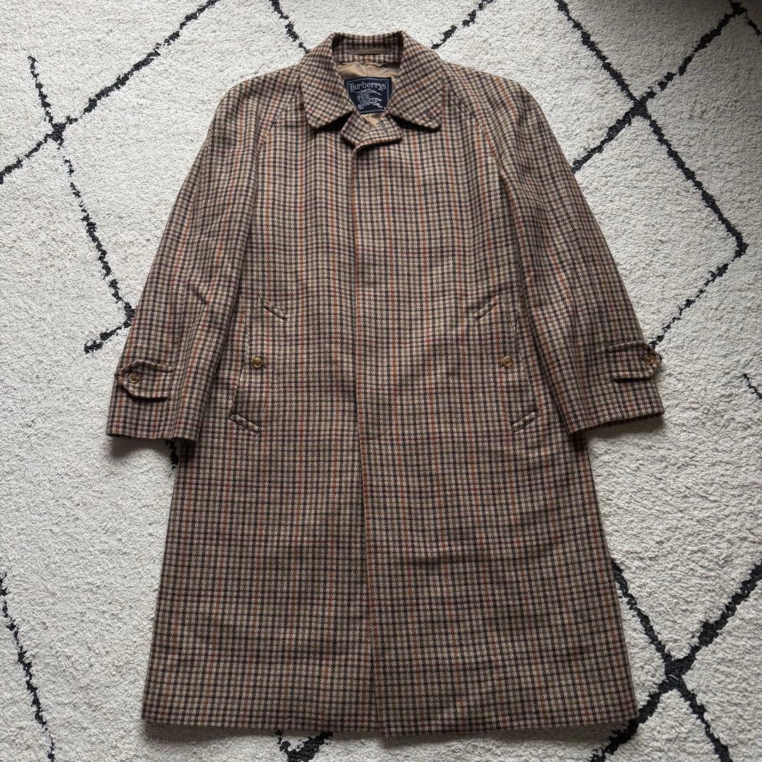 Front view of the Burberrys cashmere-blend Balmacaan coat in gun club check pattern laid flat.