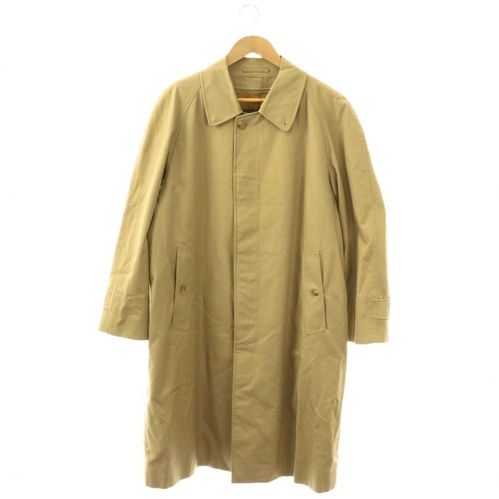 Front view of a long beige trench coat hanging on a hanger.