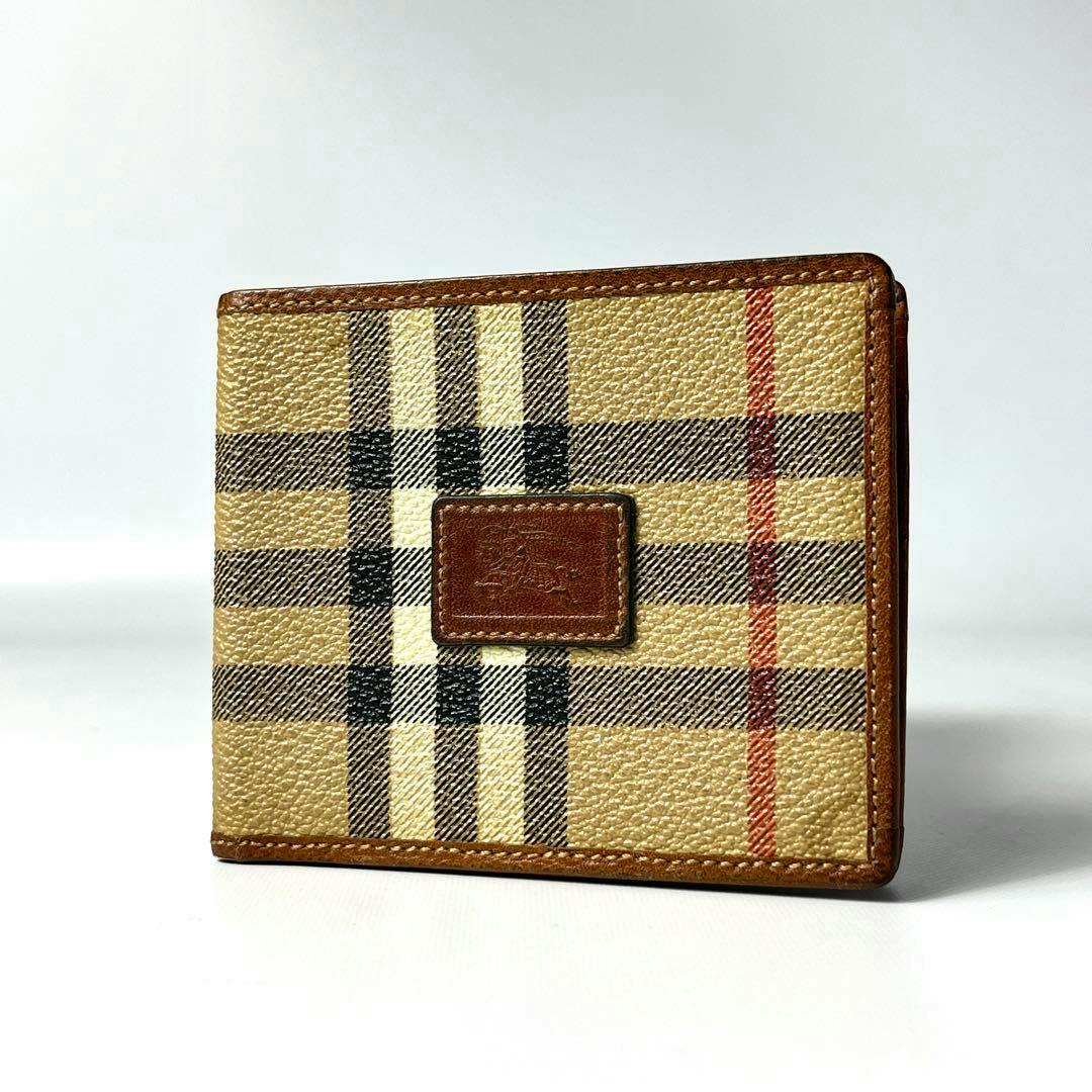 Front view of a Burberrys two-fold wallet in beige Nova Check PVC with leather trim and a central leather logo patch.