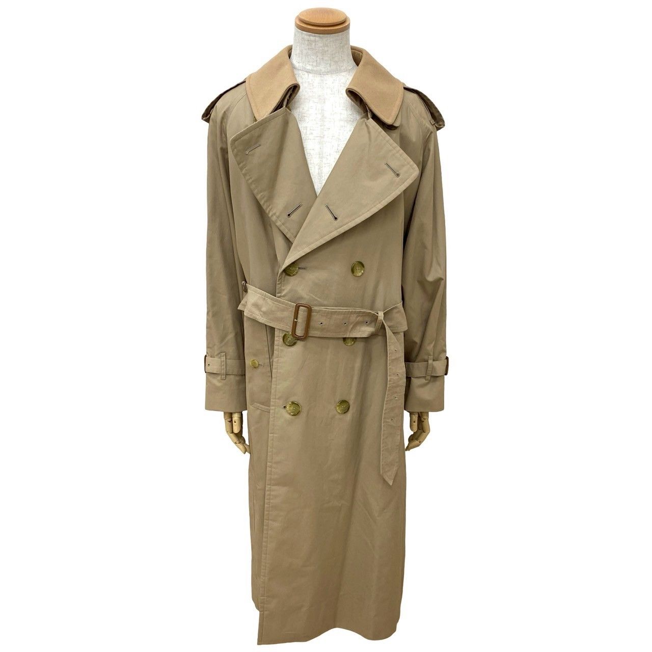 Beige Burberrys trench coat with a belt displayed on a torso mannequin.
