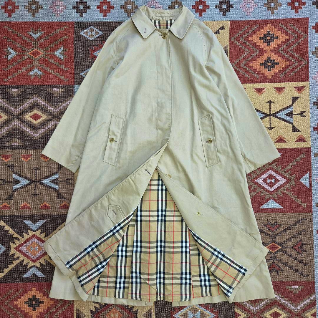Beige women's cotton stand-collar coat laid flat with the beige check lining visible.