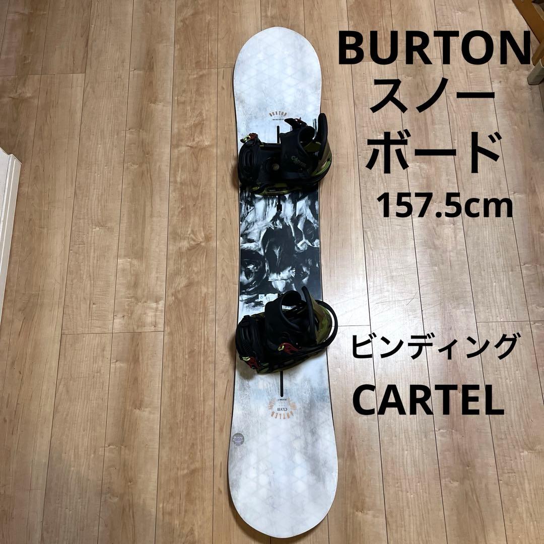 Top-down photo of a Burton snowboard with mounted bindings on a wooden floor, with a text overlay reading 157.5cm.