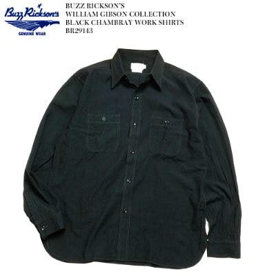Black chambray men's work shirt laid flat showing collar, long sleeves, and two chest pockets.