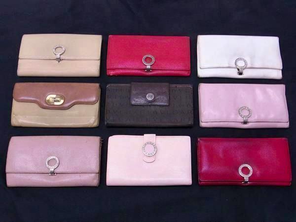 Nine BVLGARI cow leather wallets in various colors arranged on a black surface.