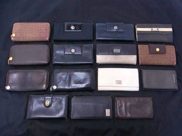 Fifteen BVLGARI and similar wallets arranged in rows on a dark background, top-down view.