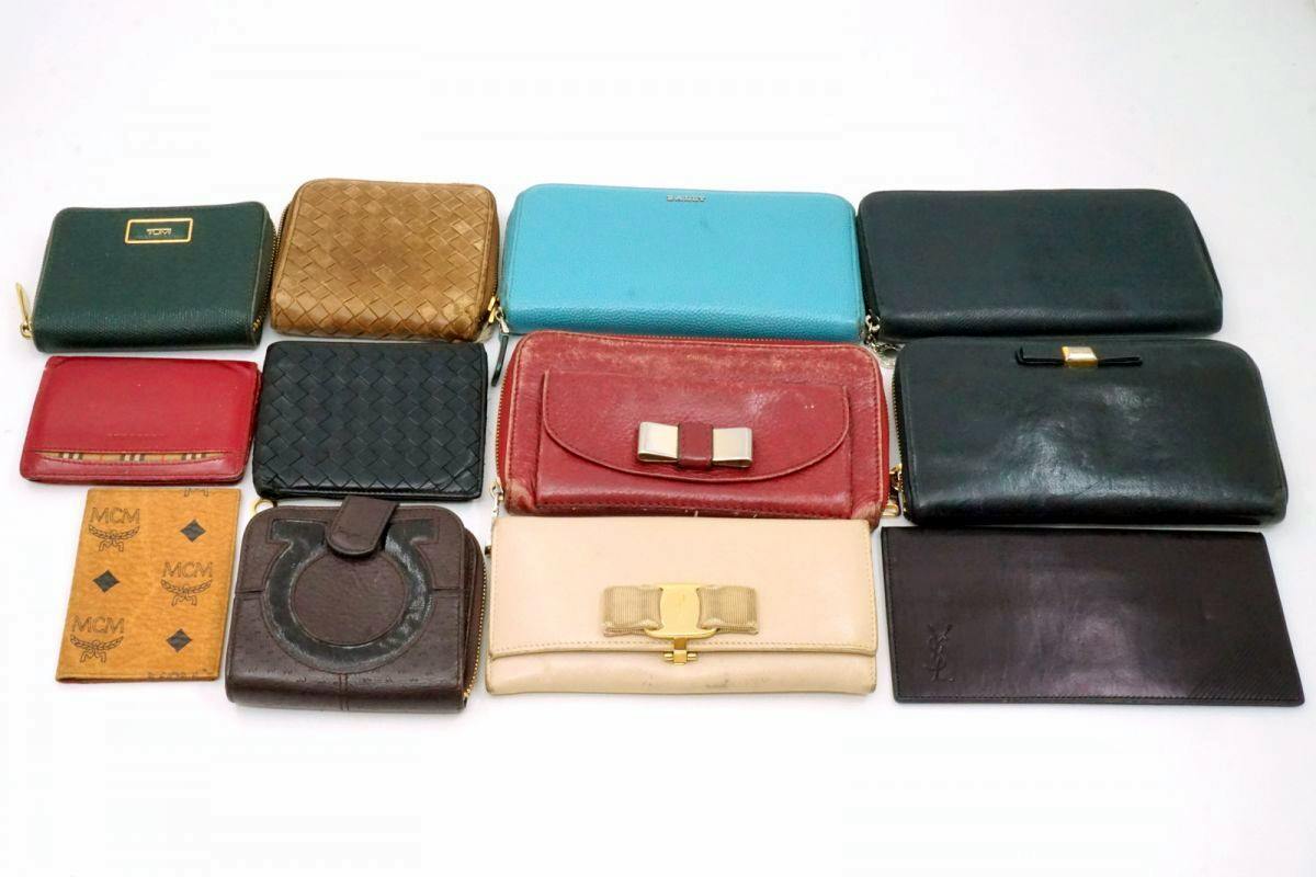 Twelve assorted long wallets and pass cases arranged in a grid on a white background.