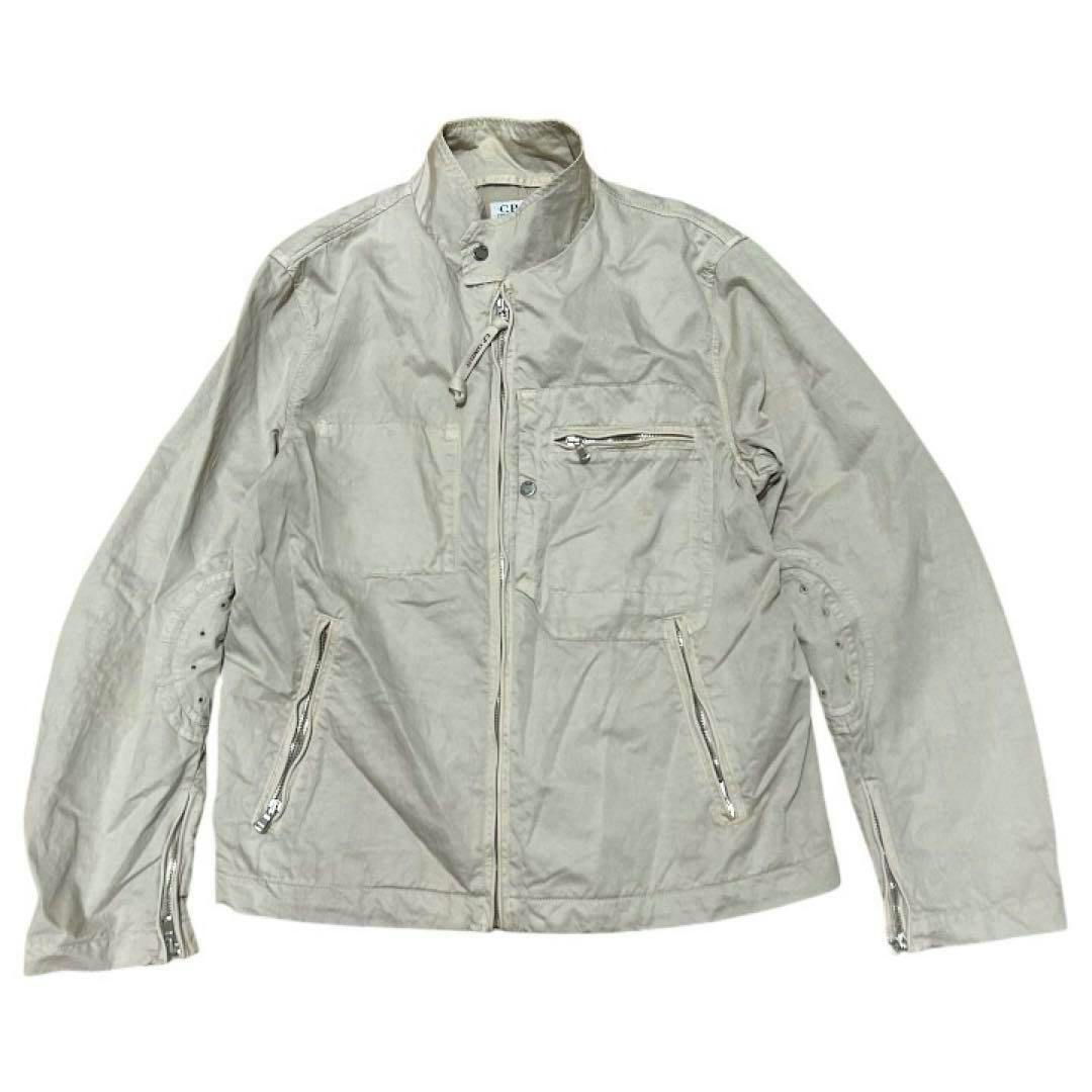 Front view of a C.P. COMPANY cotton no-collar design men's jacket laid flat showing the front zipper and zippered pockets.