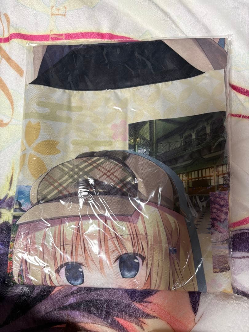 Folded polyester happi in plastic packaging showing a printed anime character face.