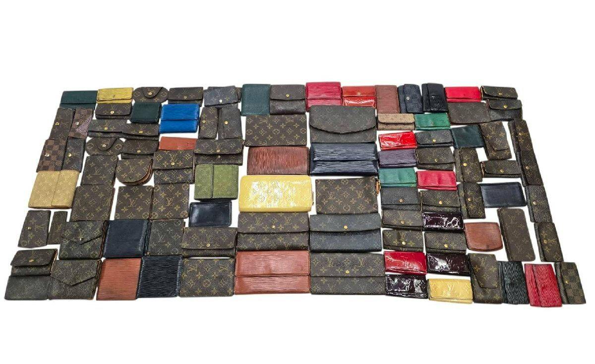Many Louis Vuitton wallets and small cases in monogram, Damier, Epi, and patent finishes arranged on a white background.