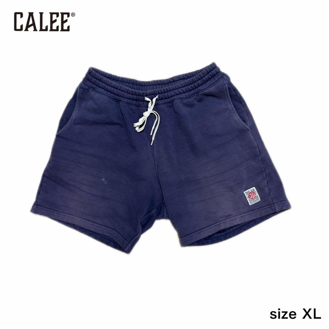 Flat-lay navy CALEE sweat shorts with drawstring and a small square logo patch on a white background.
