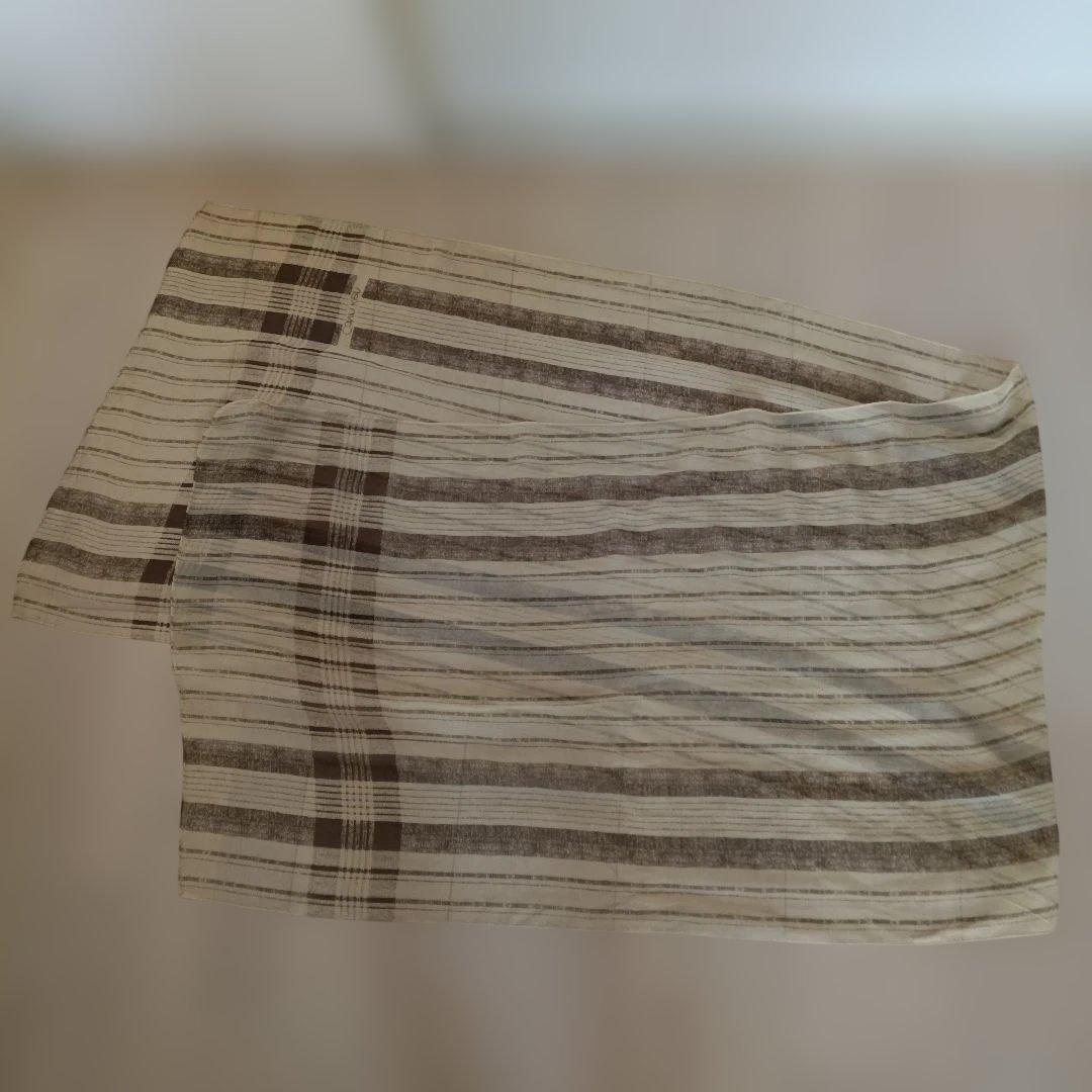 Beige check-pattern cotton scarf (51×180 cm) laid flat showing the striped design.