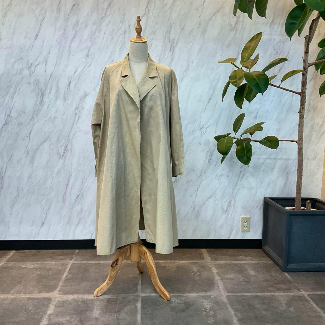 Front view of a Calvin Klein women's coat displayed on a dress form against a marble-patterned wall.
