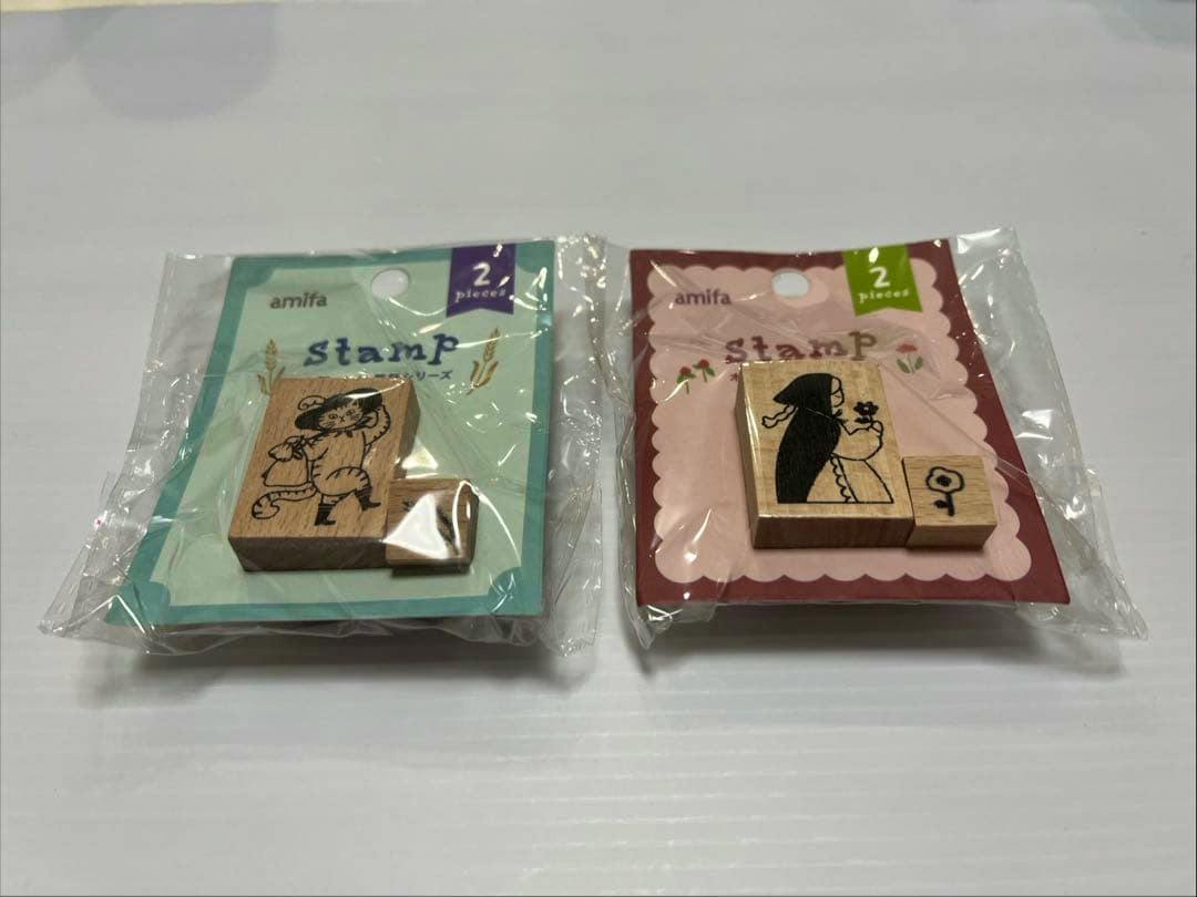 Two sealed wooden stamp packages from the fairy-tale series shown side-by-side on a white surface.