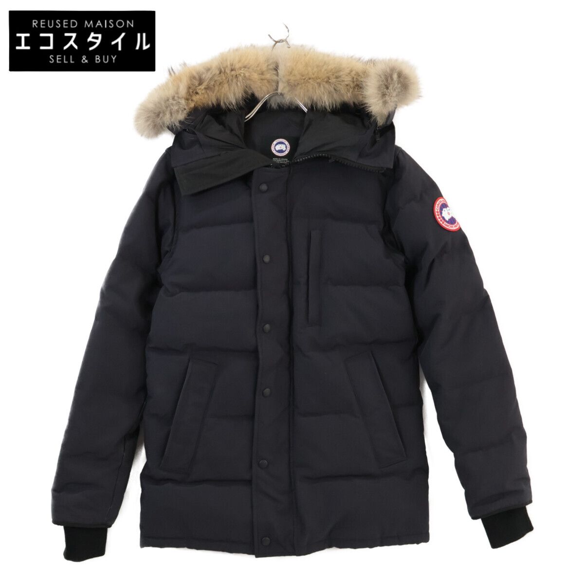 Front view of a CANADA GOOSE men's Carson parka jacket in black with a fur-trimmed hood hung on a hanger.