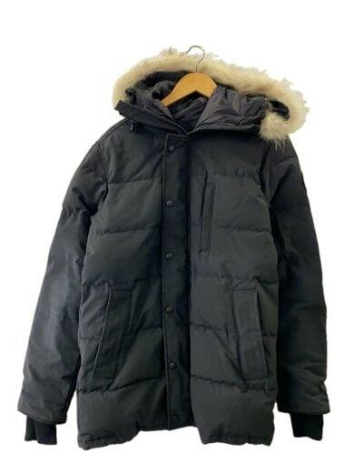 Front view of a black Canada Goose men's down jacket with a fur-trimmed hood on a hanger.