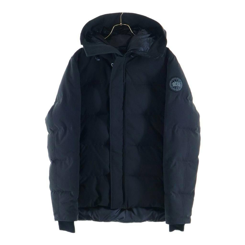 Front view of a black Canada Goose MacMillan Parka hooded down jacket hanging on a hanger against a white background.