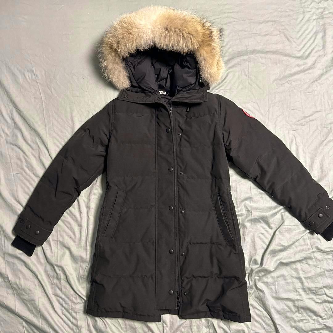 Black Canada Goose Shelburne women’s parka with a fur-trimmed hood shown laid flat from the front.