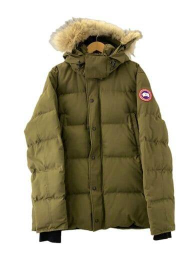 Front view of a khaki Canada Goose Wyndham down parka with fur-trimmed hood and logo patch on the sleeve displayed on a hanger.