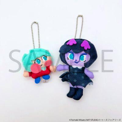 Two plush keychain mascots (Amé and Caries) with ball chains displayed on a white background.