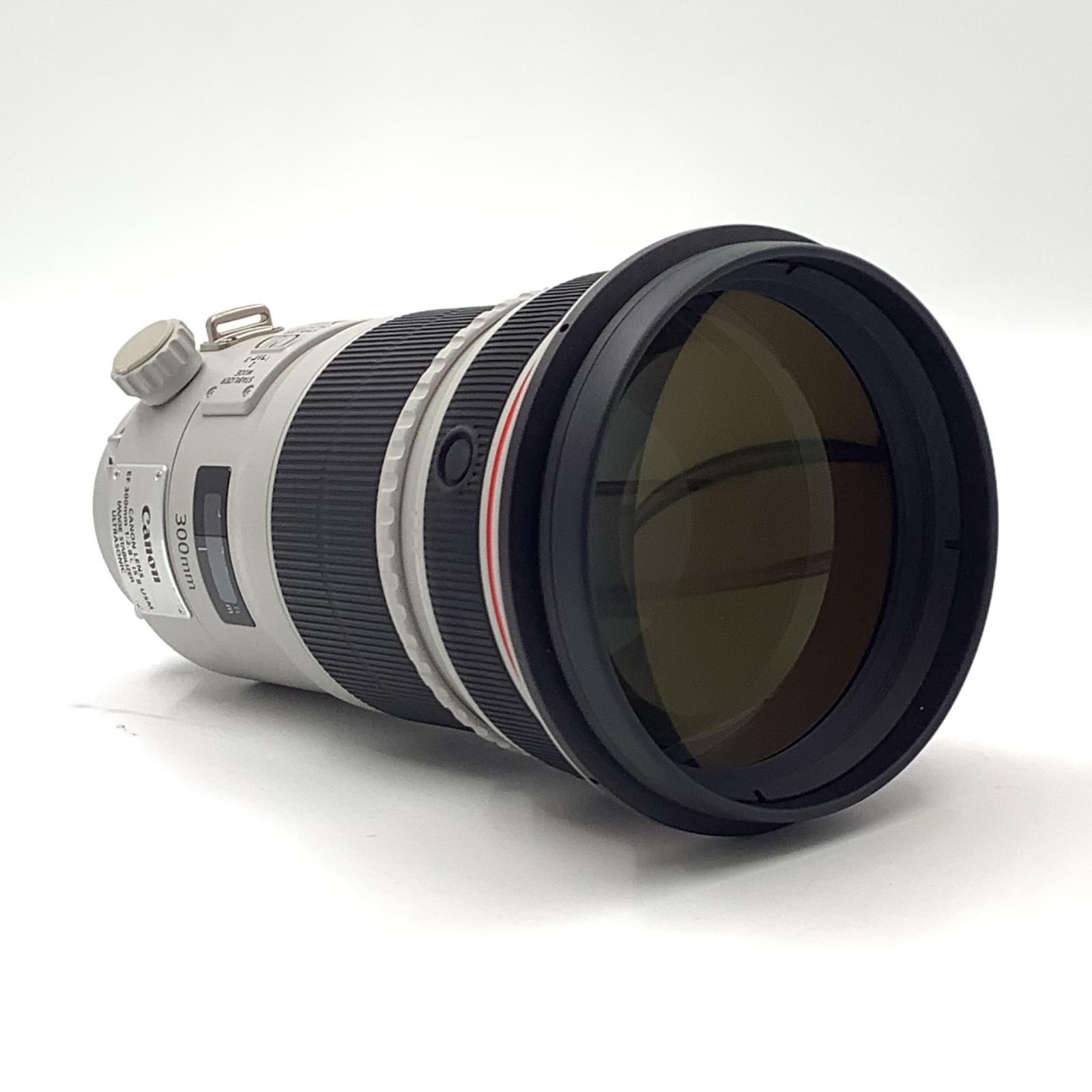 Canon EF300mm F2.8L IS II USM camera lens lying on its side showing the front element.