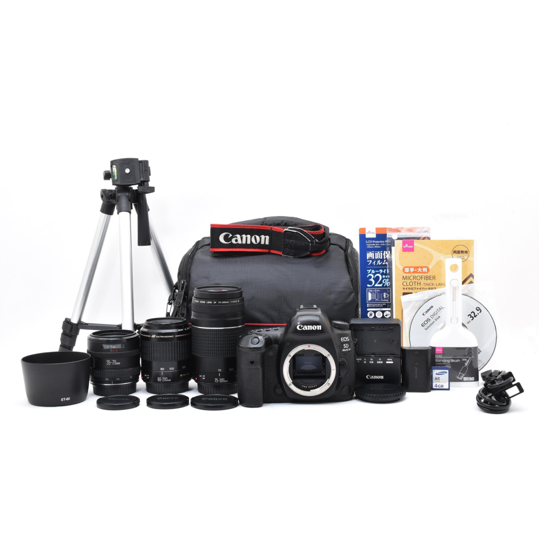 Canon EOS 5D Mark IV camera body with lenses and accessories arranged on a white background.