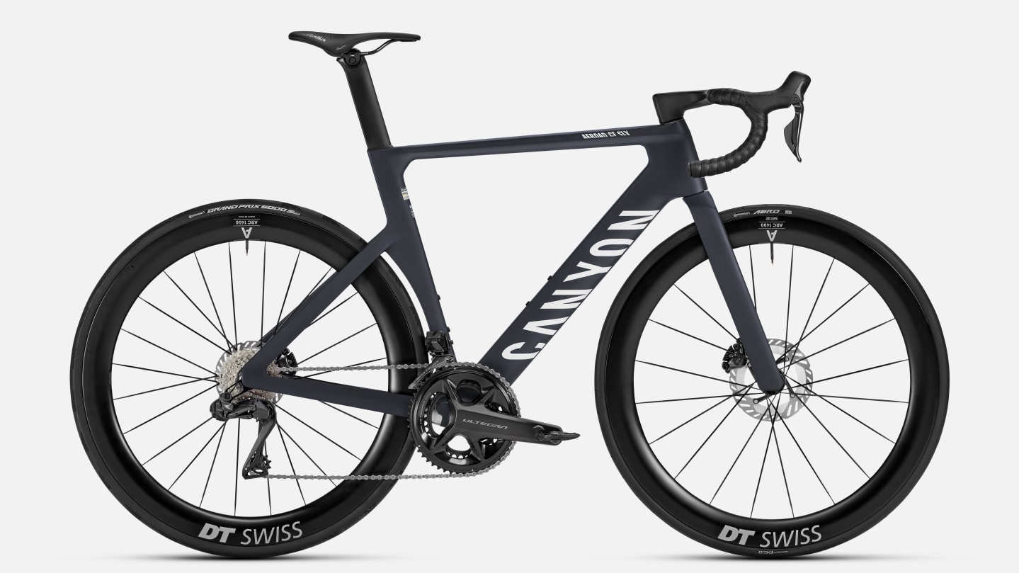 Full side view of the Aeroad CF SLX 8 Di2 road bicycle showing the frame, wheels, drivetrain, and integrated cockpit on a plain light background.