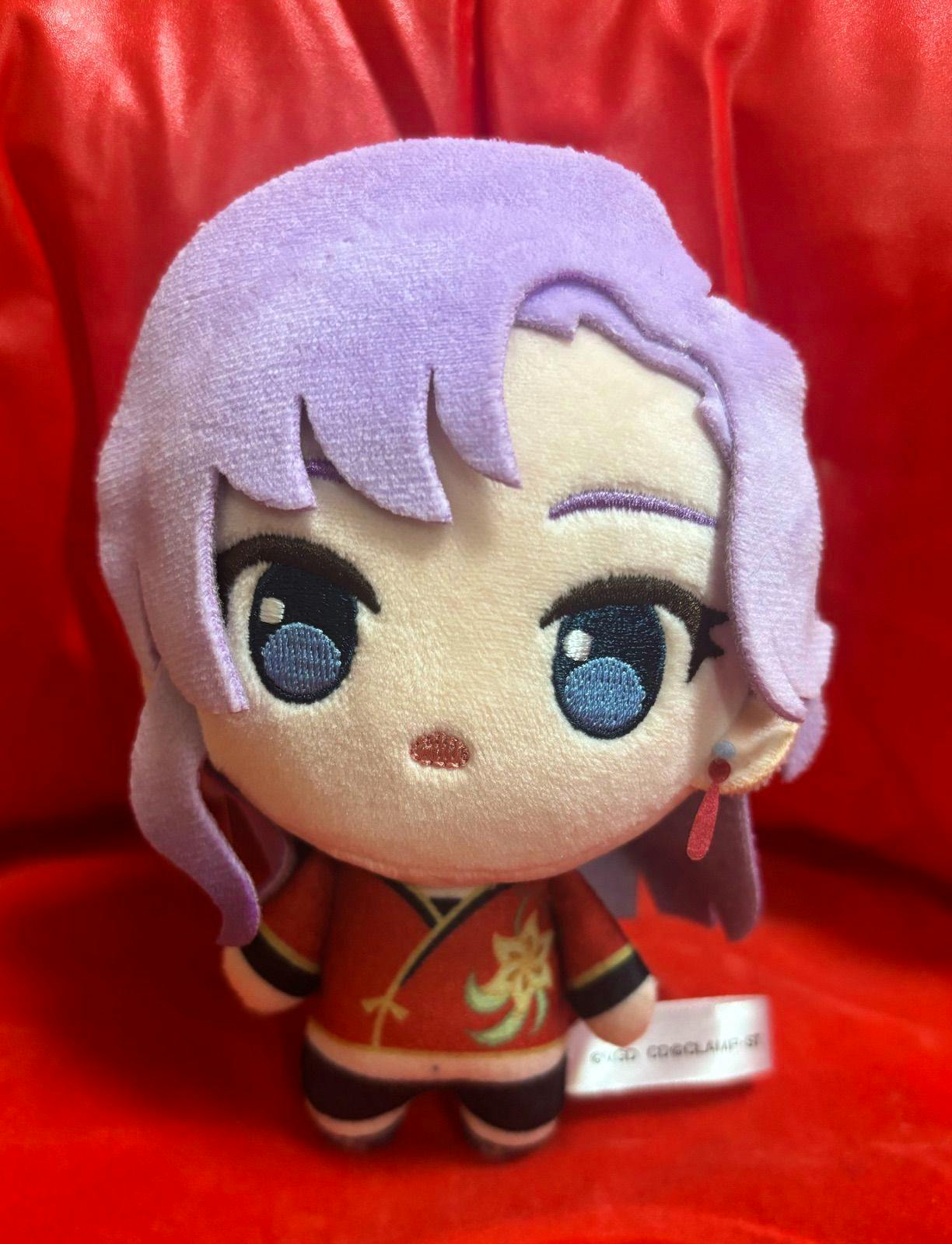Front view of the plush toy 『員弁ナオ』 showing purple hair, embroidered eyes, and a red outfit.