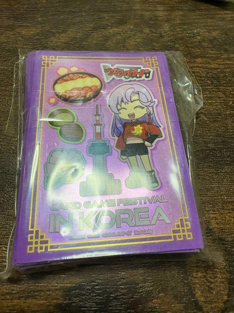 Packaged purple card sleeves showing a chibi character illustration and the text "IN KOREA".
