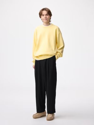 Male model wearing the men's polyester carrot slacks in a full-length studio shot.