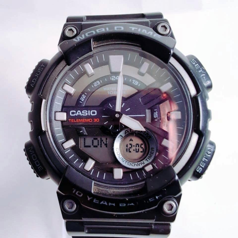 Front view of the Casio AEQ-110W analog-digital wristwatch showing the dial, hands, and digital subdisplay.