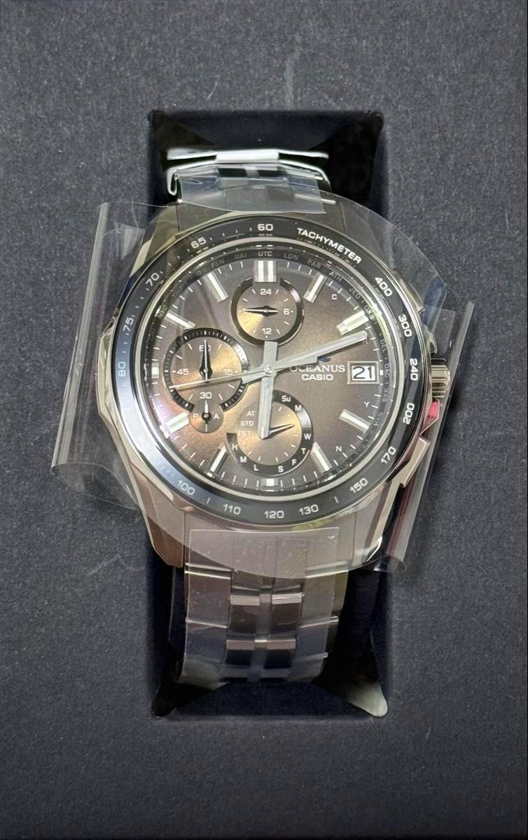Photograph of the CASIO OCEANUS Manta OCW-S7000RA-5AJF watch in its box with protective plastic film on the case and bracelet.