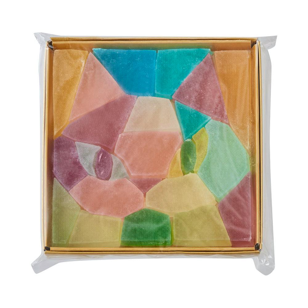 Square box of packaged colorful sugar candies arranged into a cat-face mosaic.