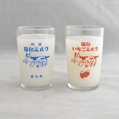 Two drinking glasses with cat-print milk designs, one printed in blue and one in red, shown with milk inside.